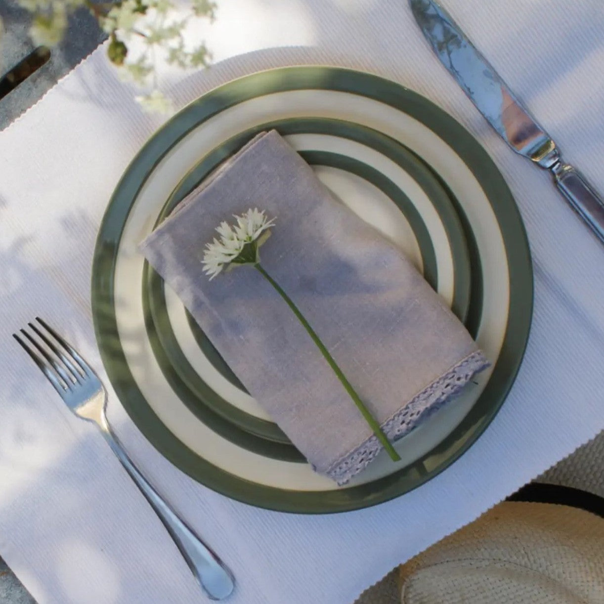 Cornishware Willow Green gebaksbord en dinerbord op tafel met servet en witte bloem
